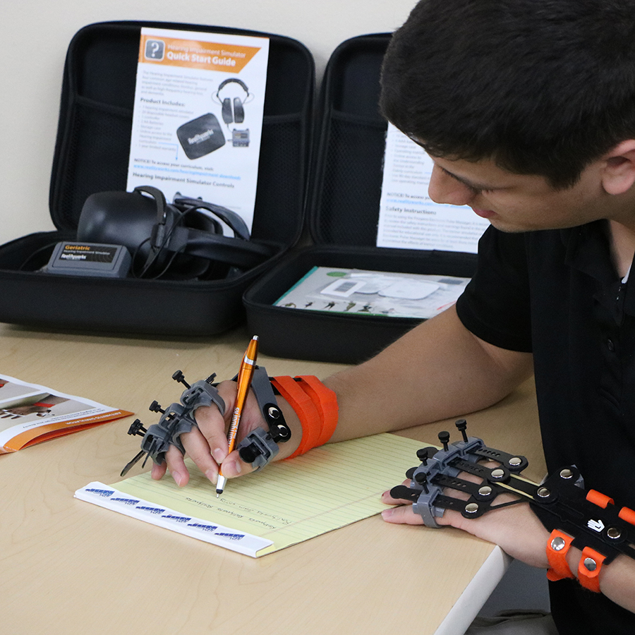 Image of medical specialist trying out the Geriatric Arthritis Simulator